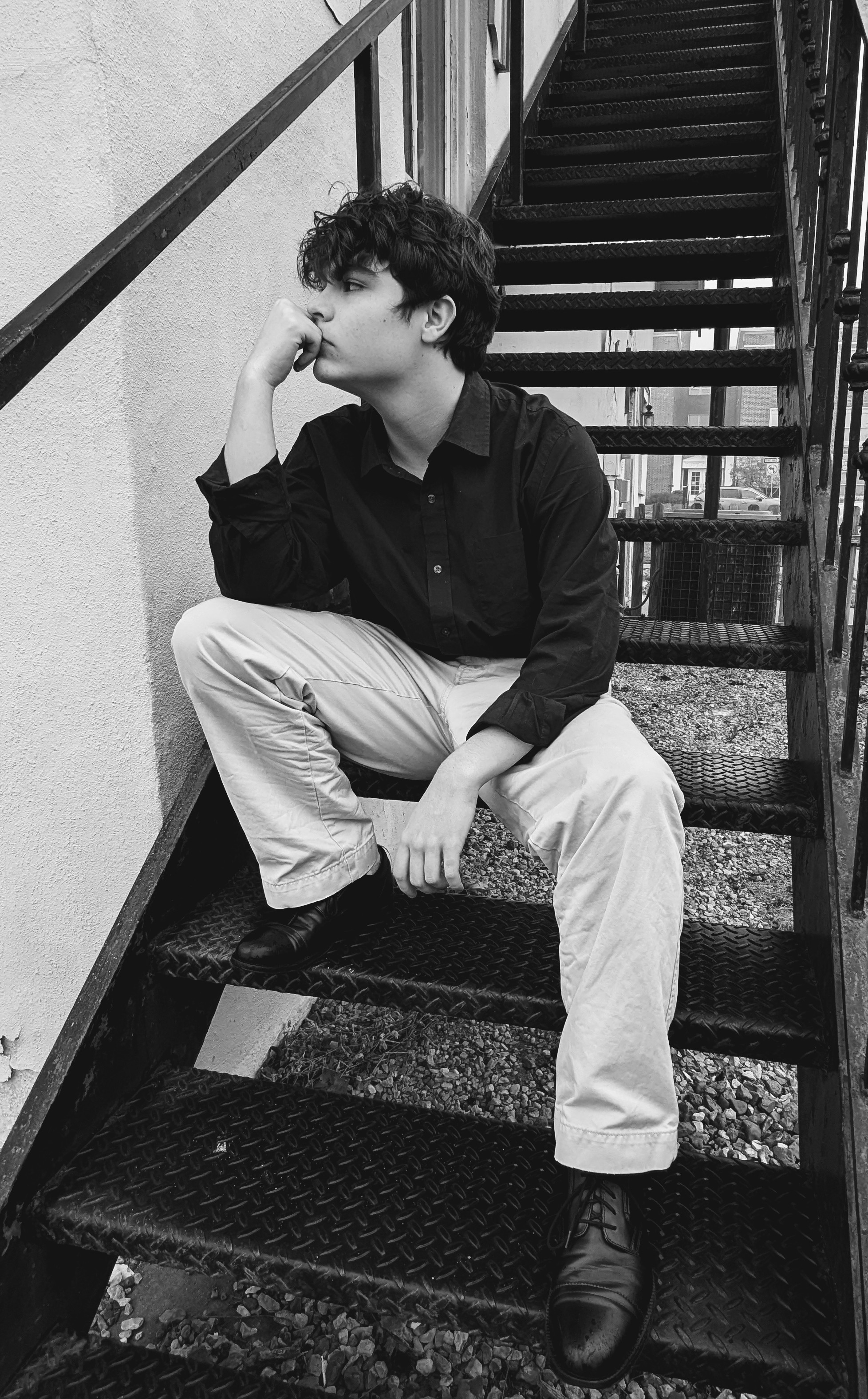 Isaac Bailey seated by stairs
